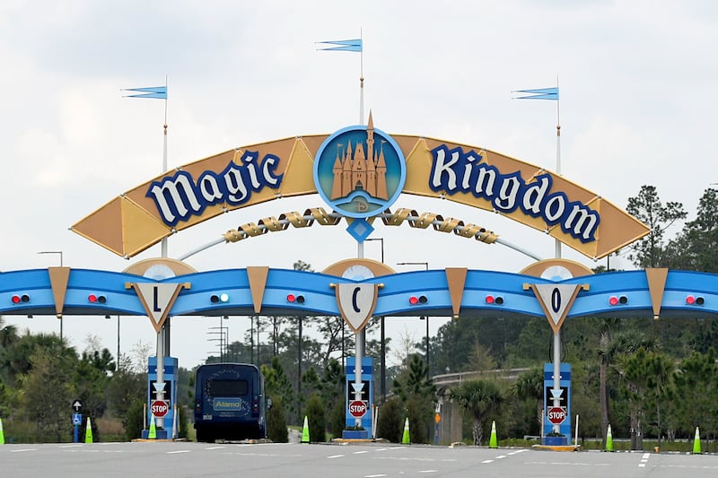 In this March 16, 2020, file photo, the entrance to the parking lot at the Magic Kingdom at Walt Disney World is closed in Lake Buena Vista, Fla. Squeezed by limits on attendance at its theme parks and other restrictions due to the pandemic, The Walt Disney Co. said Tuesday, Sept. 29, 2020, it planned to lay off 28,000 workers in its parks division in California and Florida.
