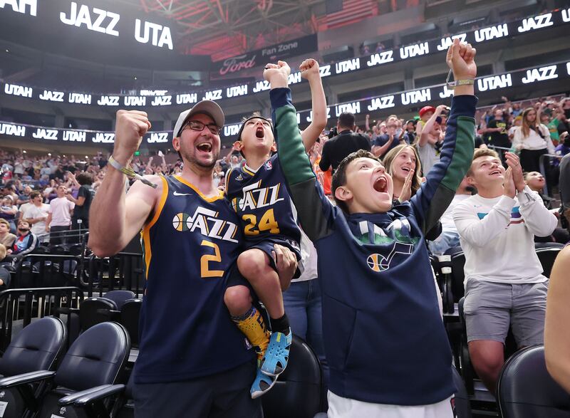 Mike Shackelford cheers with his sons Lucas and Ethan as the Utah Jazz choose Taylor Hendricks as their first pick in the NBA draft.