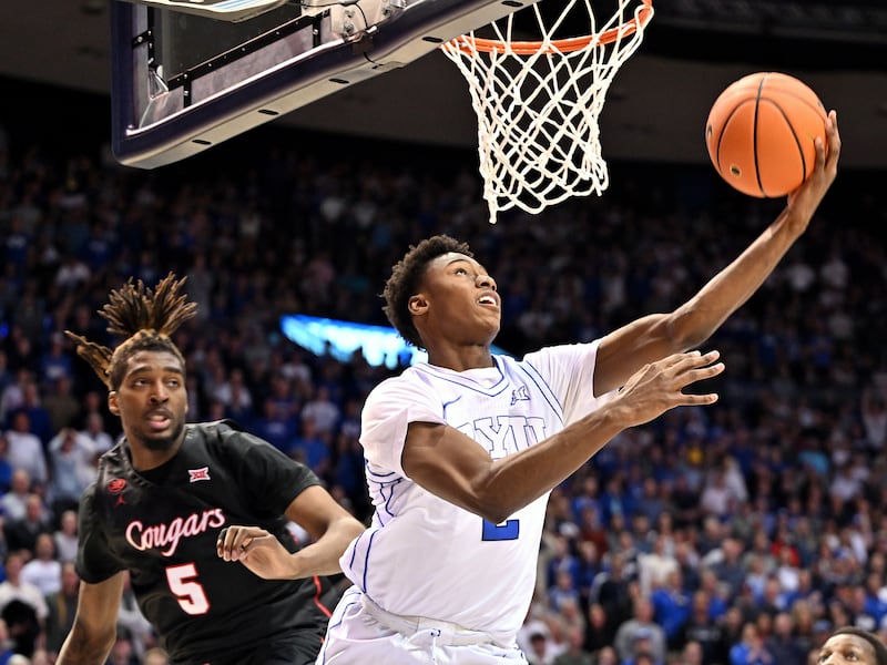 BYU Cougars guard Jaxson Robinson (2) flips up a shot as he slips past Houston Cougars forward Ja’Vier Francis (5).