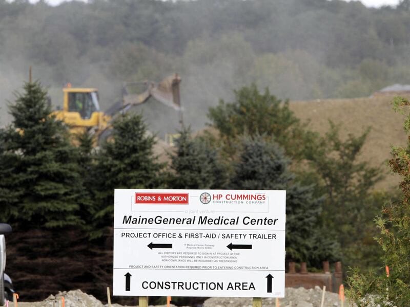 In this Monday, Sept. 19, 2011 photo, a bulldozer works in the background at the site of a new hospital being built in Augusta, Maine. Officials at Maine General say the project, due for completion in 2014, will be a big economic boost to the region. Whe