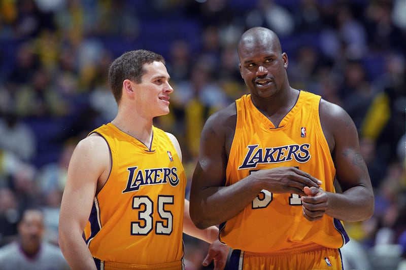 Shaquille O’Neal and Mark Madsen of the Los Angeles Lakers speak during a NBA game against the Miami Heat at the Staples Center in Los Angeles, Calif.
