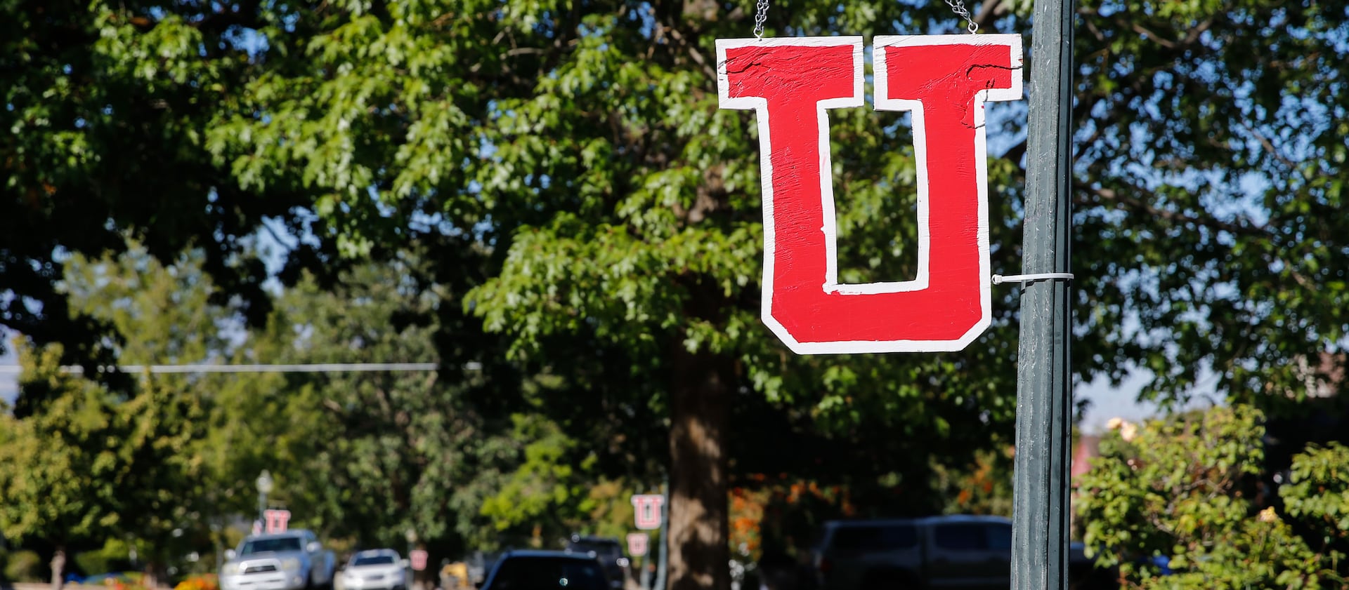 A “U” sign hangs in the Salt Lake City neighborhood near where University of Utah football player back Aaron Lowe was killed.