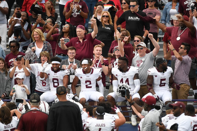 Southern Illinois players celebrate after defeating Northwestern at the end of a game, Sept. 17, 2022, in Evanston, Ill.
