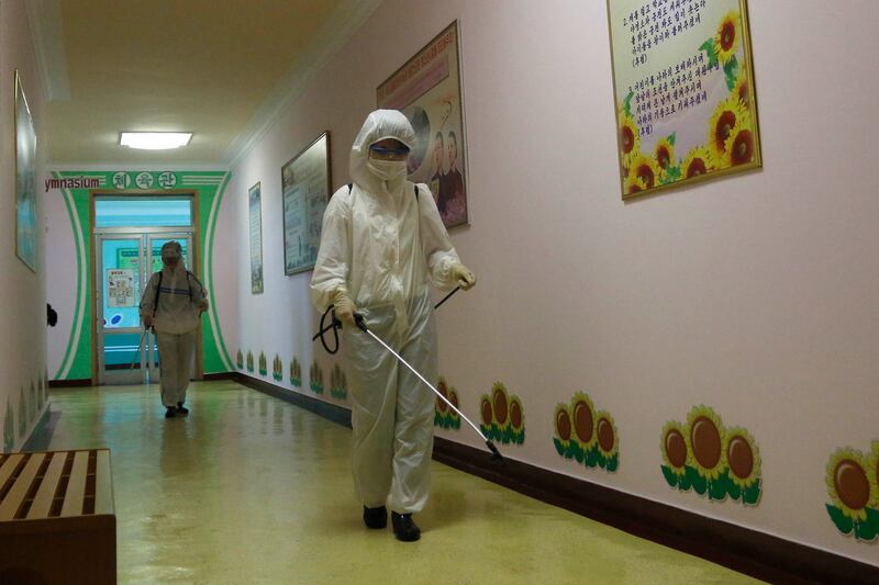 Staff of the Pyongyang Primary School No. 4 clean classroom desks in Pyongyang, North Korea.