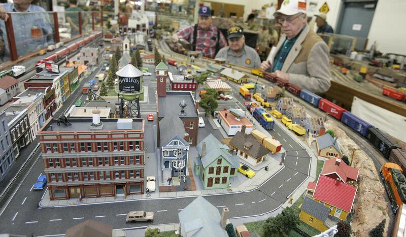 In this photo taken Nov. 27, 2011, members of the Gadsden Pacific Division Toy Train Operating Museum operate trains around the toy town named Fairweather in Tucson, Ariz.