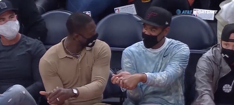 Utah Jazz part owner Dwyane Wade and PGA Tour golfer Tony Finau discuss golf during the Jazz’s game against the Oklahoma City Thunder at Vivint Arena in Salt Lake City, Utah, on Wednesday, Oct. 20, 2021.