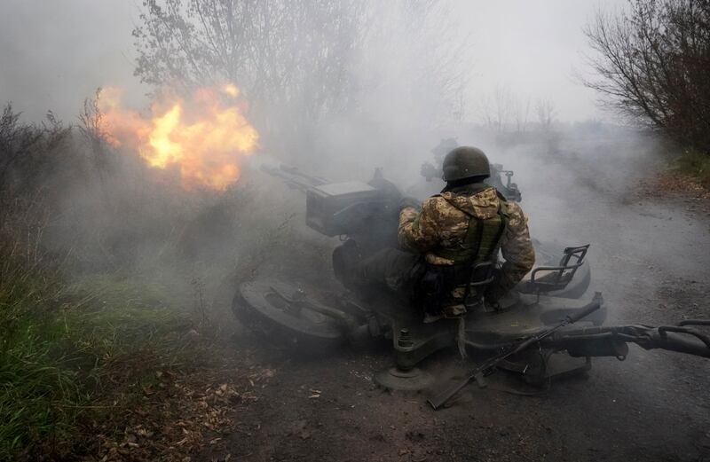 Ukrainian National Guard soldiers fire at Russian positions from an anti-aircraft gun in Kharkiv region, Ukraine, on Friday, Nov. 11, 2022.