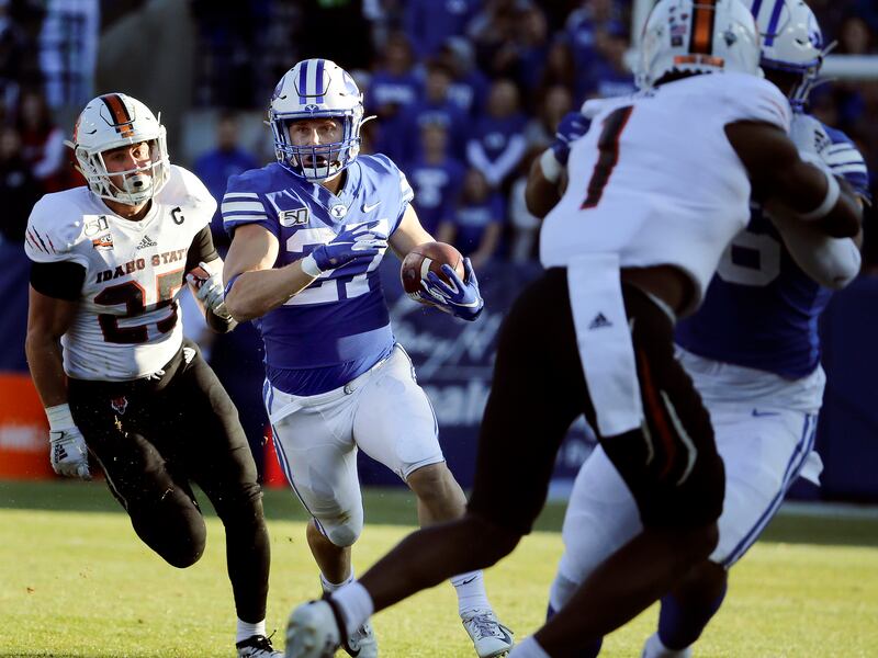 BYU running back Jackson McChesney runs past Idaho State linebacker Kody Graves at LaVell Edwards Stadium Nov. 16, 2019.