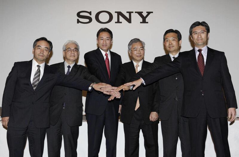 Sony Corp. President and Chief Executive Officer Kazuo Hirai, third from left, poses for photographers with the corporate executives, from left, Executive Deputy President Hiroshi Yoshioka, Executive Vice President and Chief Financial Officer Masaru Kato,