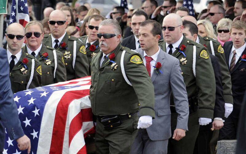 Paul Bearers carry the casket of Utah County Sgt. Cory Wride for the internment service at the Spanish Fork City Cemetery on Wednesday, February 5, 2014.