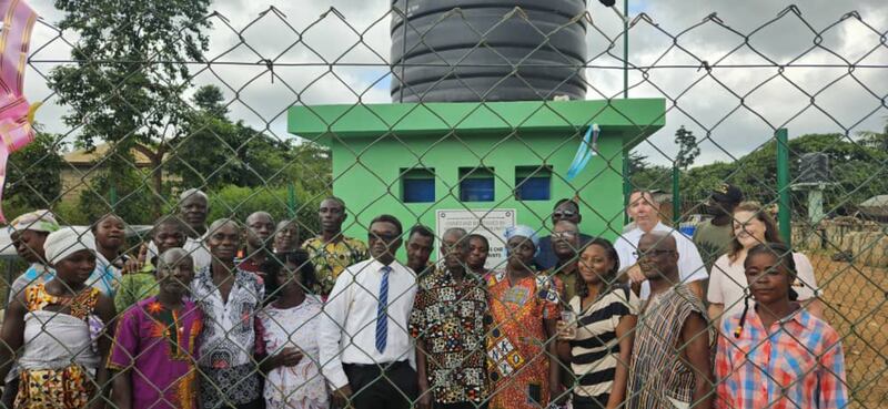Latter-day Saints and villagers pose for a photo in Addokrom, Ghana, on July 22, 2025, after the Church's donation of a water borehole.