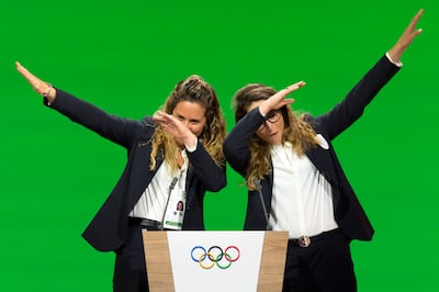Italian snowboarder Michela Moioli, left, and Italian skier Sofia Goggia, right, dab after speaking during the presentation final presentation of the Milan-Cortina candidate cities the first day of the 134th Session of the International Olympic Committee