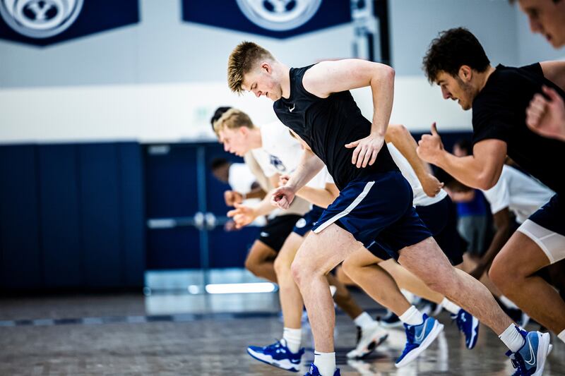 BYU players run during a summer workout at the practice facility in Provo, Utah.