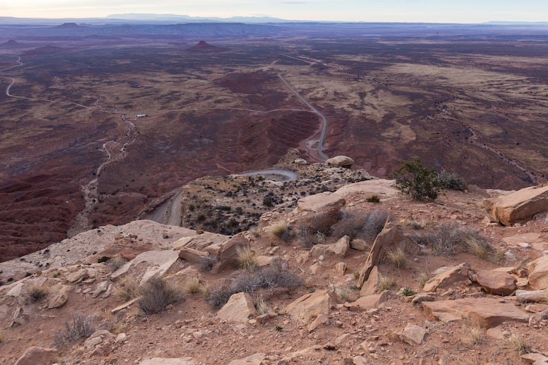 FILE - The view down the Moki Dugway switchbacks from the top of Cedar Mesa overlooks Valley of the Gods, Mexican Hat and the rim of the San Juan River. Starting a trip in Mexican Hat was to "start off into empty space from the end of the world," author W