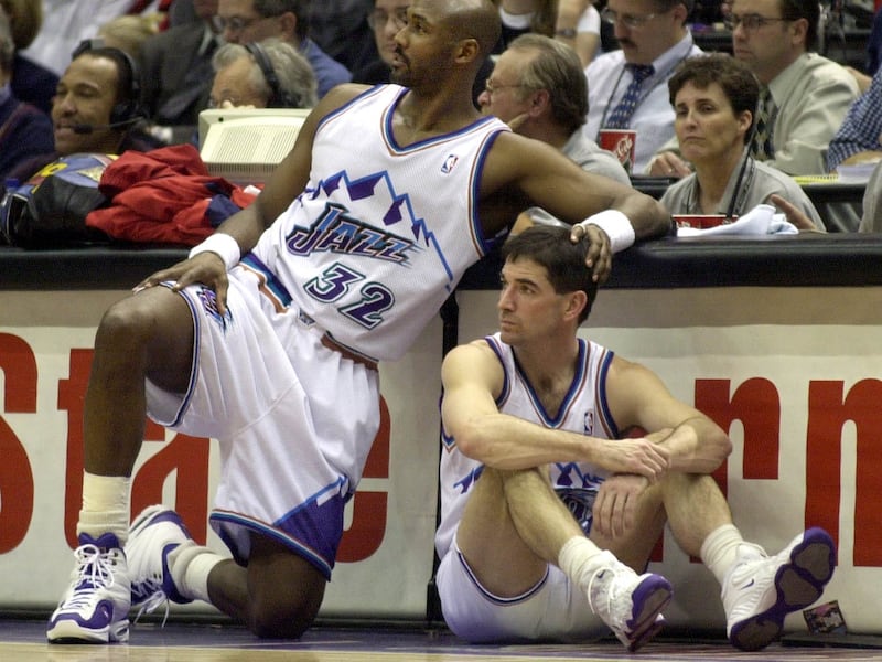 Malone gives Stockton a touch on the head as they wait to go into the game against Charlotte. photo by ravell call, feb. 1, 2001. (Submission date: 02/11/2005)