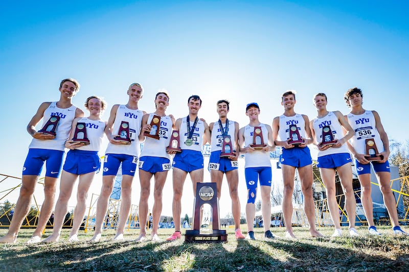 Members of the BYU men’s cross-country team pose after finishing third at the NCAA cross-country championships.