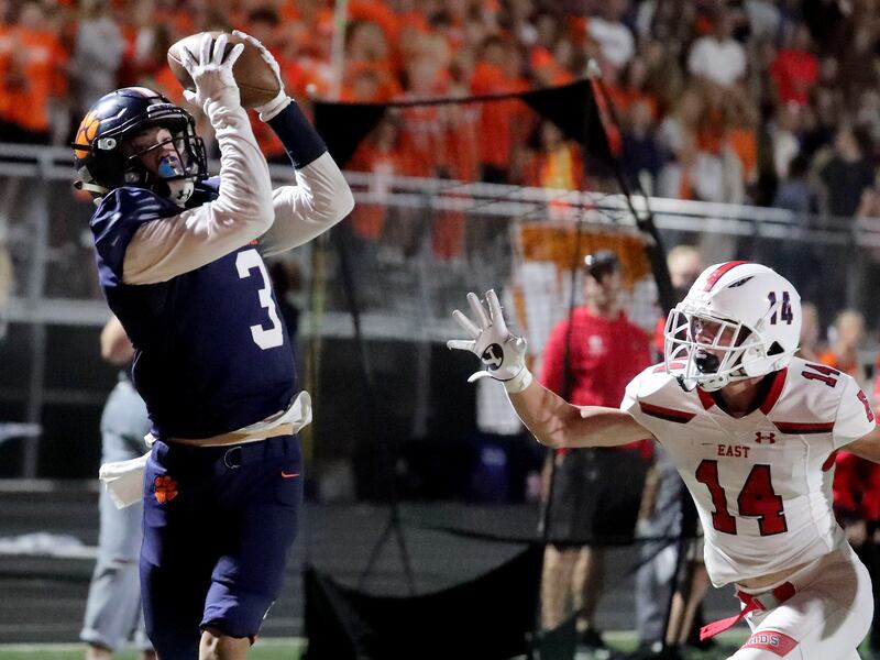 Brighton’s Dante McMaster catches a pass and scores in the first half against East’s Chase Barker at Brighton High School in Cottonwood Heights on Thursday, Sept. 22, 2021.