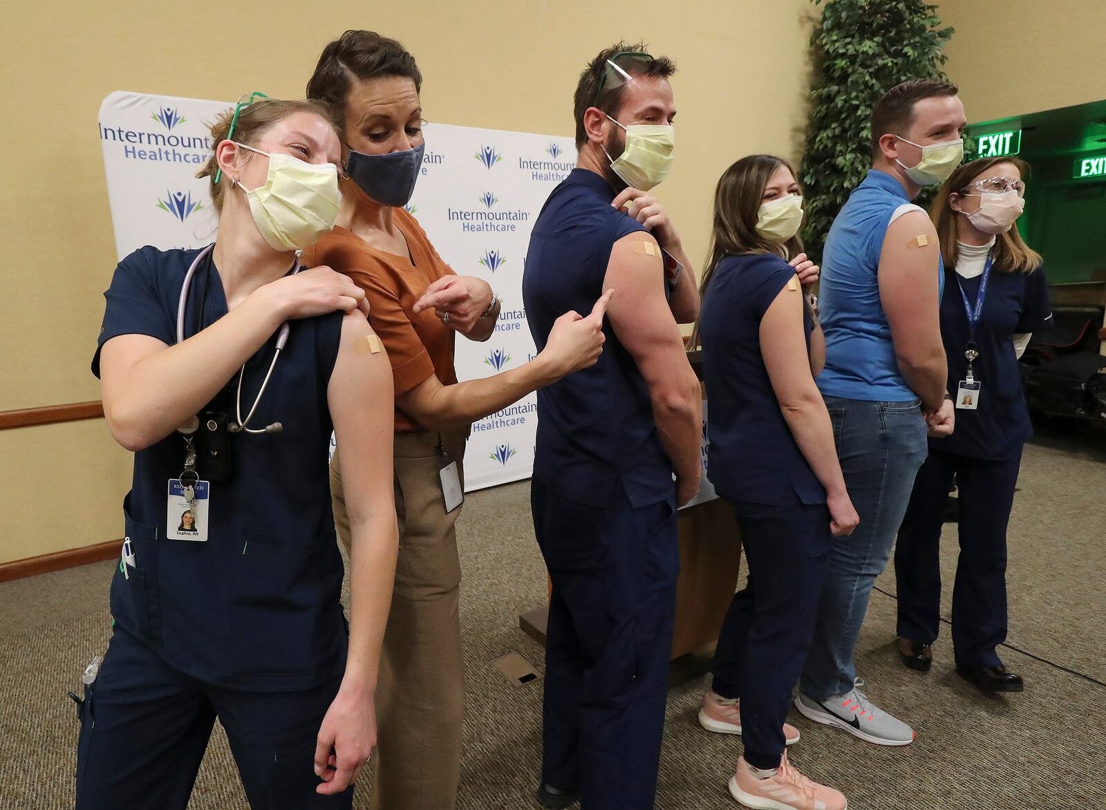 Registered nurses poses for a photo with then-state epidemiologist Dr. Angela Dunn after being vaccinated for COVID-19.