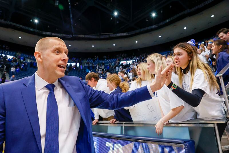 BYU’s coach Mark Pope high-fives fans after beating the Nicholls State Colonels at the Marriott Center on Nov. 19, 2022.