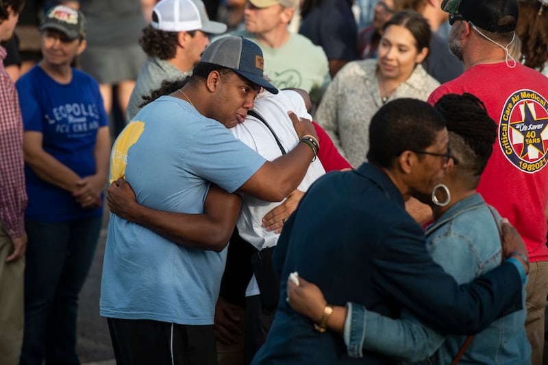 Community members embrace during a prayer vigil at First Baptist Church in Dadeville, Ala., on Sunday, April 16, 2023.