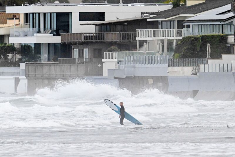 A surfer enters the water at La Jolla Shores Tuesday, Jan. 23, 2024, in La Jolla, California.