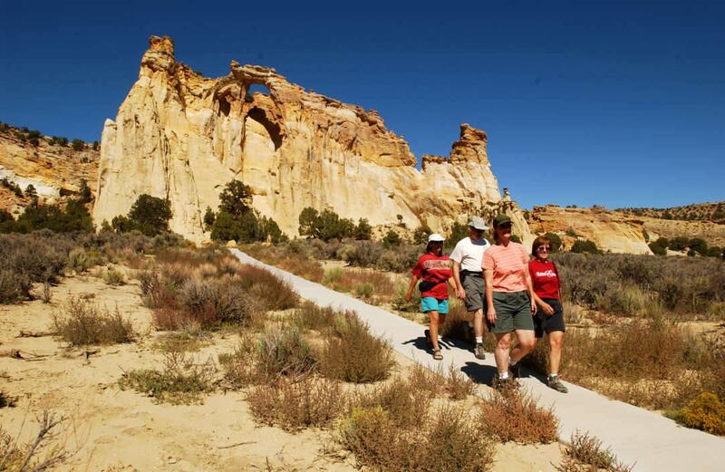 Left to right, kathy Whitney, Mike Whitney, Leslie Fowler and Paula Fowler walk down the the path leading to Grosvenor Arch in the Grand Staircase Escalante National Monument.