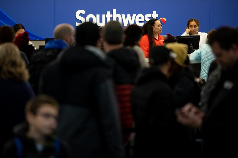 People wait in line for assistance at the Southwest Airlines counter at Salt Lake International Airport in Salt Lake City on Tuesday, Dec. 27, 2022.