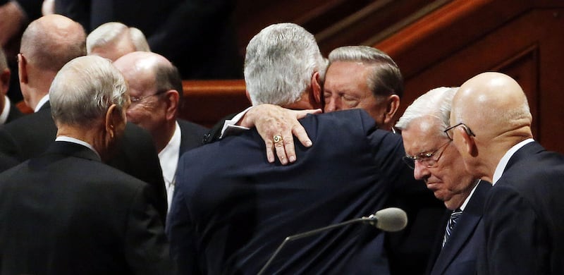 Elder Jeffrey R. Holland hugs President Dieter F. Uchtdorf, back to camera, after the Saturday morning session of the 187th Semiannual General Conference of The Church of Jesus Christ of Latter-day Saints in Salt Lake City on Saturday, Sept. 30, 2017.