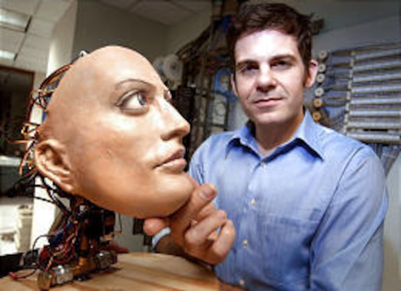 "Sculptor roboticist" David Hanson poses with Hertz, an animated robot head.