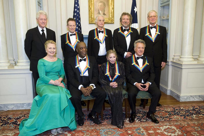 From left, former President Bill Clinton, Secretary of State Hillary Rodham Clinton join the 2012 Kennedy Center Honorees John Paul Jones, Buddy Guy, Jimmy Page, Natalia Makarova, Robert Plant, Dustin Hoffman, and David Letterman for a group photo after t