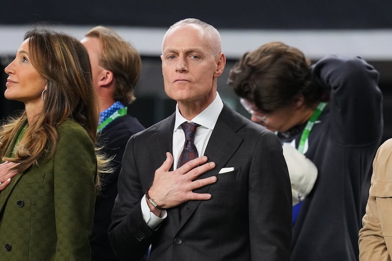 FILE - Big 12 Commissioner Brett Yormark stands on the sideline during the playing of the national anthem before the first half of a Big 12 Conference championship NCAA college football game between BYU and Texas Tech Dec. 6, 2025, in Arlington, Texas. (AP Photo/Julio Cortez, File)