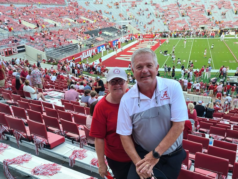 David and Karen Potter pose for a photo in Alabama’s Bryant-Denny Stadium