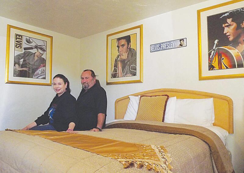 El Trovatore Motel owners Monica and Sam Frisher sit in the Elvis Presley-themed room Monday April 2, 2012. There are 19 other themed rooms, and the couple has plans for more in the future.