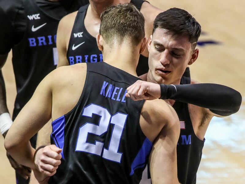 Brigham Young Cougars guard Alex Barcello (13) hugs his teammates and coaches.