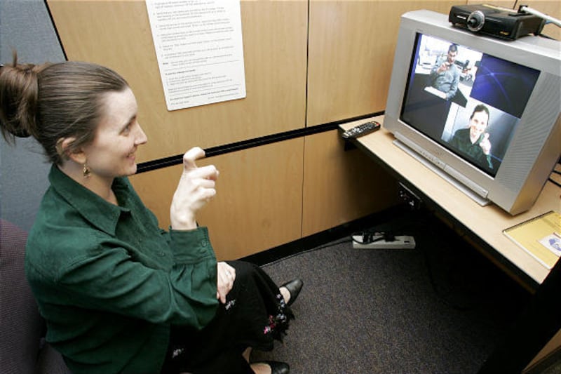 April Trocki uses video conferencing at the Robert G. Sanderson Community Center of the Deaf and Hard of Hearing in Taylorsville.