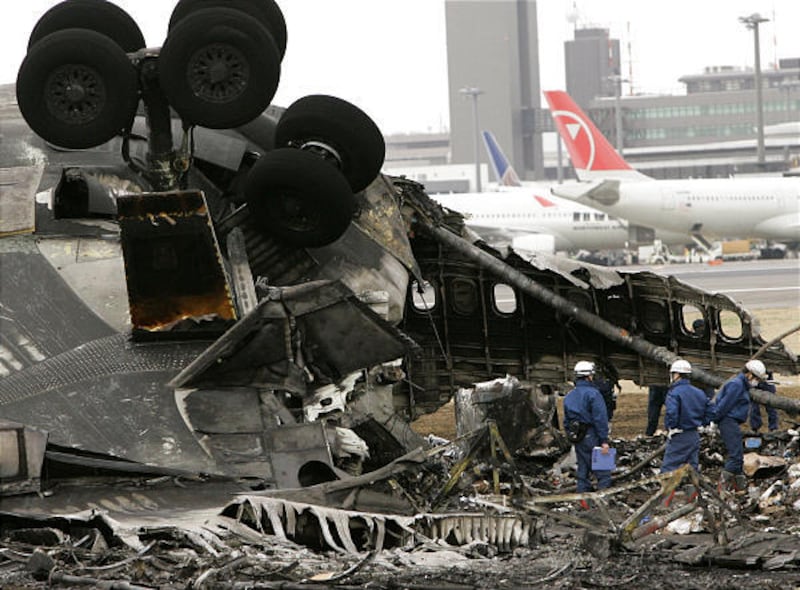 Investigators inspect a FedEx cargo plane after it crashed and burst into flames at Narita International Airport, east of Tokyo, on Monday.