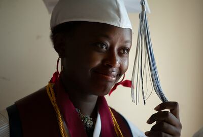 Desange Kuenihira adjusts her tassel while waiting for her graduation ceremony from Itineris Early College High School to begin at Thanksgiving Point in Lehi on Wednesday, May 15, 2019. When Kuenihira was a young girl growing up in a refugee camp without