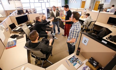 FILE - Domo Technologies employees hold a standing meeting in American Fork Wednesday, March 30, 2016.