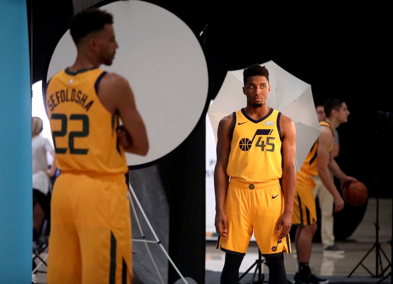 Thabo Sefolosha, Donovan Mitchell and Grayson Allen pose for individual portraits at different photography stations during Jazz media day at the Zions Bank Basketball Center in Salt Lake City on Monday, Sept. 24, 2018.