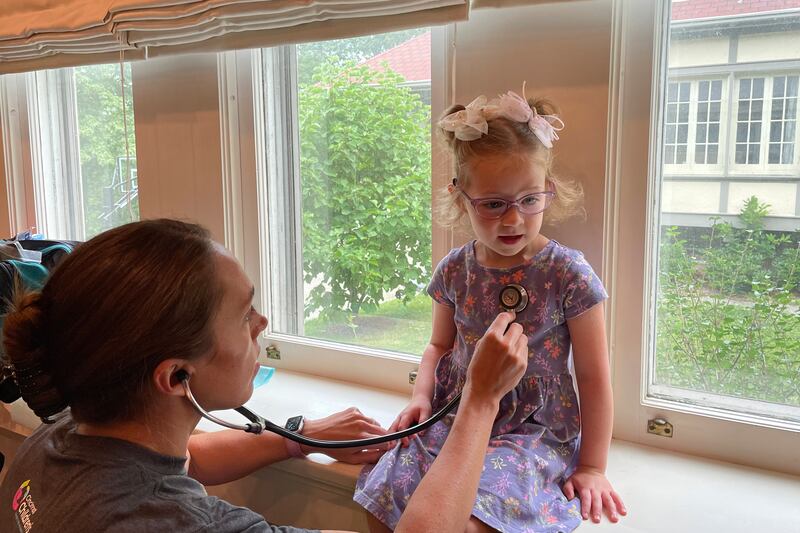 Courtney Chase listens to 4-year-old Brynn Schulte’s heart.