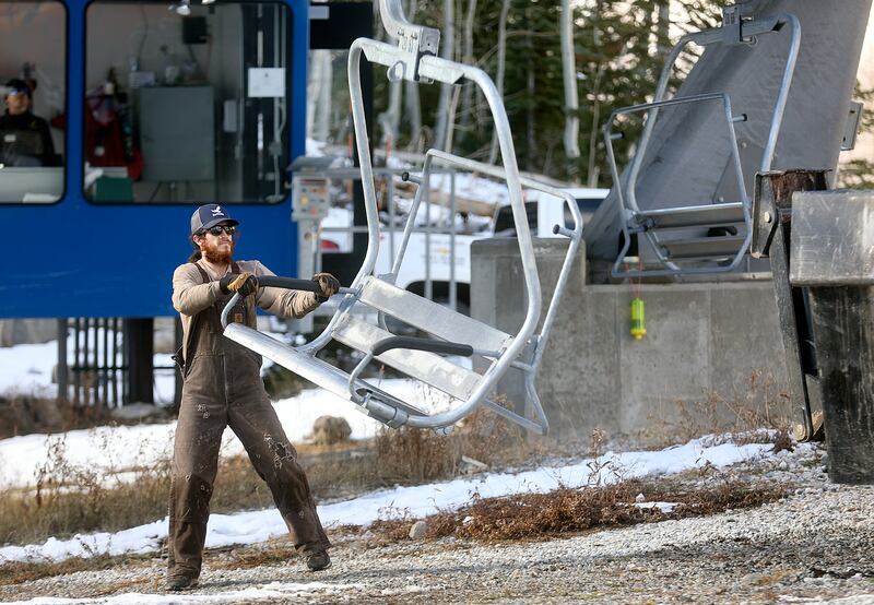 Cody Reed loads chairs onto the Moonbeam Express chairlift at Solitude Mountain Resort in Salt Lake City.