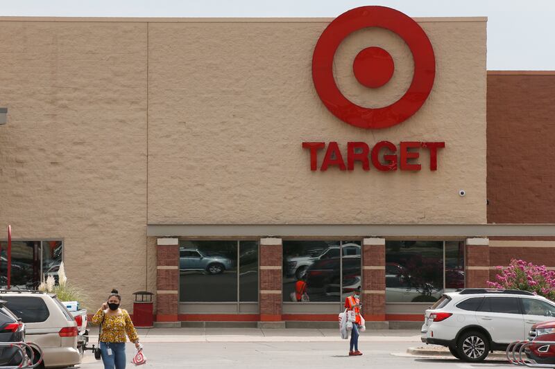 People walk through the parking lot at a Target store in Oklahoma City.