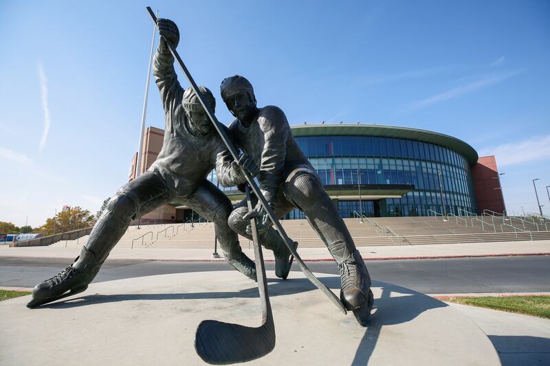 A sculpture of hockey players at the Maverik Center in West Valley City.
