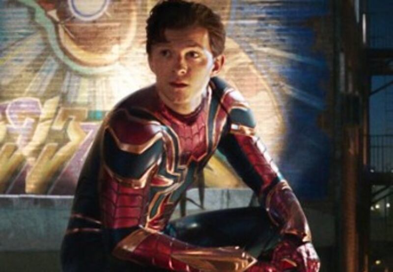 The poster shows Peter Parker/Spider-Man (Tom Holland) crouched on the top of a building with a mural honoring Iron Man (Robert Downey Jr.) right behind him. 'Spider-Man: Far From Home' open soon.
