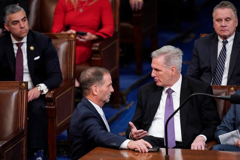 Rep. Chris Stewart, R-Utah talks with Rep. Kevin McCarthy, R-Calif., in the House chamber in Washington, on Jan. 4, 2023.