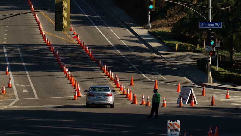 A single motorist queues up to take a coronavirus test in a parking lot at Dodger Stadium’s drive-thru testing site in Los Angeles, Monday, Jan. 11, 2021.