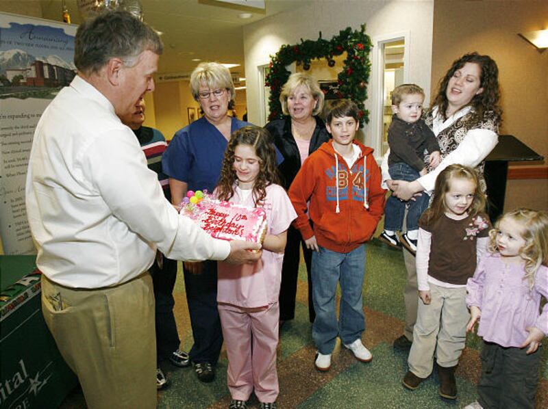 Keith Tintle helps Brighton Thorn — the first baby delivered at Timpanogos Hospital — mark her 10th birthday Monday.