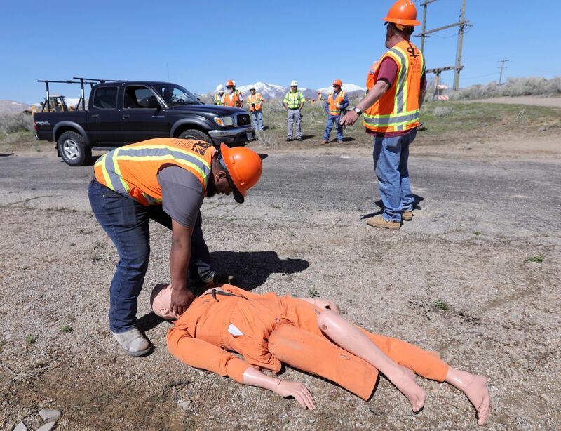 Siaosi Tupouata, a Salt Lake County district worker, checks for a pulse on a mannequin during debris management training during the Great Utah ShakeOut at the Welby Pit in South Jordan, Utah, on Thursday, April 18, 2019.