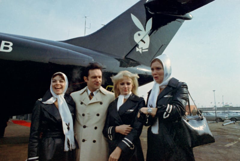 Publisher Hugh Hefner, second from left, poses in front of his new DC-9 jet with some unidentified women in February 1970.