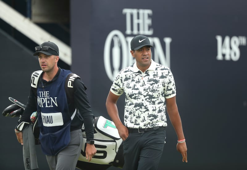 Tony Finau of the United States, right and his caddie Greg Bodine walk off the 1st tee during the third round of the British Open at Royal Portrush in Northern Ireland, Saturday, July 20, 2019. The Utah native went on to place third in the tournament.